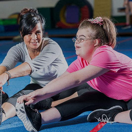 Two women with different abilities in a gym. Two women with different abilities in a gym.