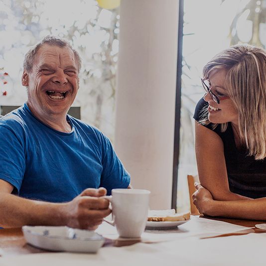 Two people smiling and both have different abilities Two people smiling and both have different abilities